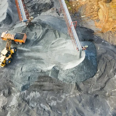 A top-down view showcasing mining operations with excavators and conveyor belts.